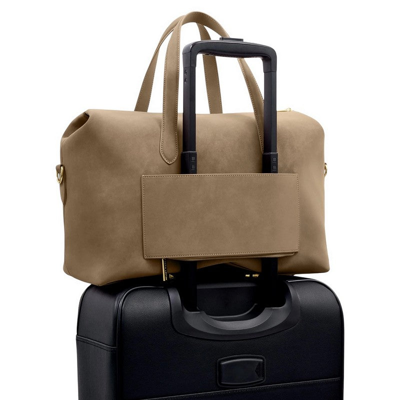 Katie Loxton Milan Cabin Bag Taupe Suedette KLB4509 strapped onto suitcase handle