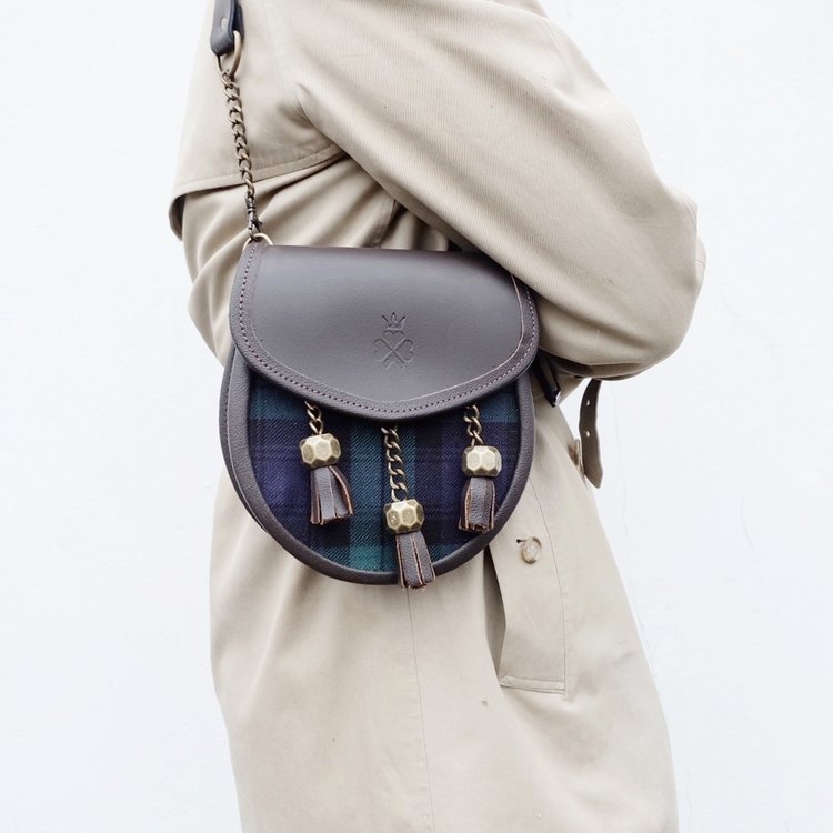 Nixey Blackwatch Sporran Handbag in Brown Leather with Bronze Fittings on model as shoulder bag