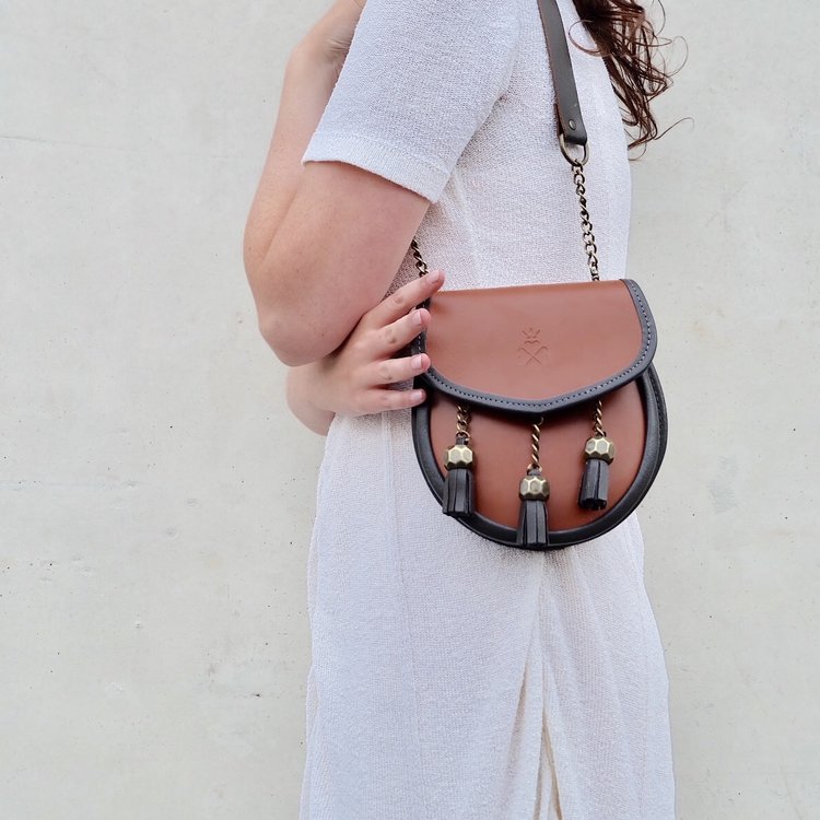 Nixey Sporran Handbag in Chestnut with Bronze Fittings over shoulder
