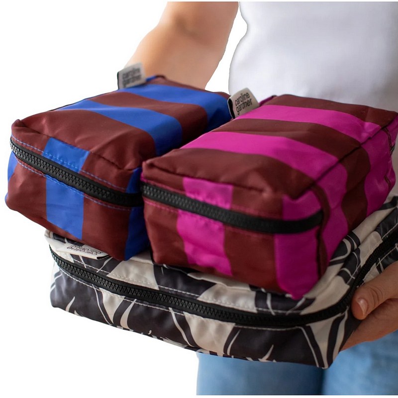 Caroline Gardner Mono Linked Hearts Stripe Set of 3 Packing Cubes ZCM100 held by model