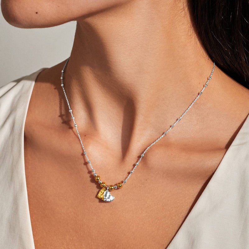 Joma Jewellery Reva Textured Offset Hearts Necklace Silver and Gold 10036 on model