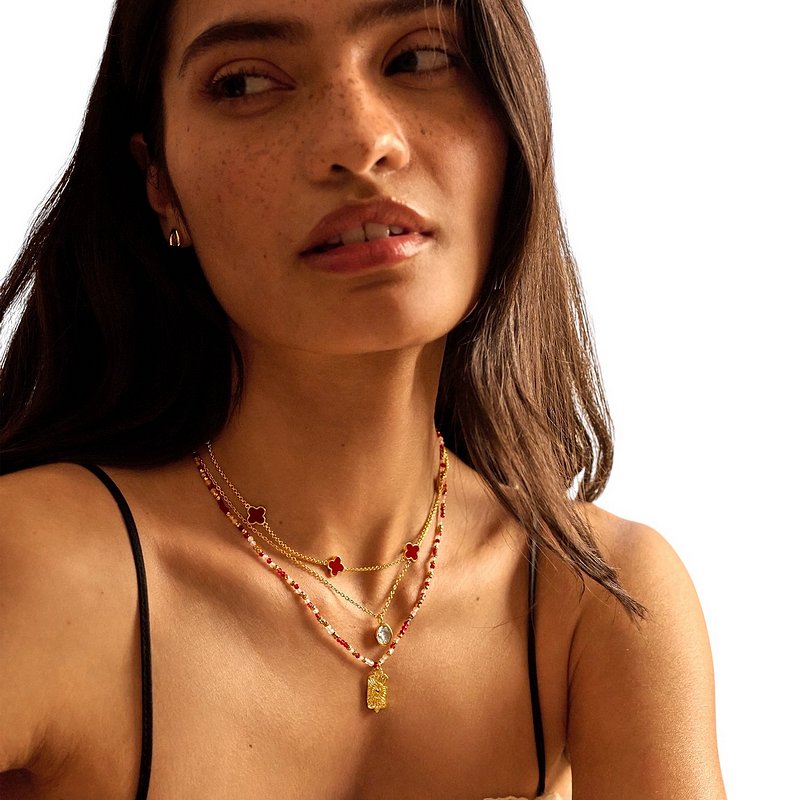 Joma Jewellery Signature Clover Collection Red Clover Necklace Gold 10575 on model with stack