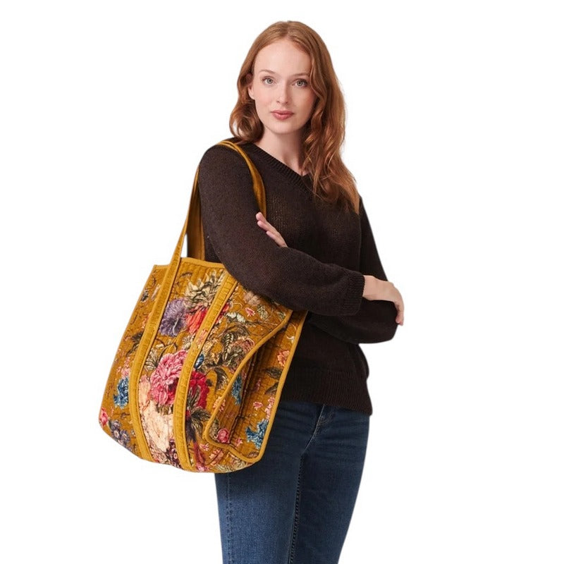 One Hundred Stars Primula Velvet Tote Bag Gold on model's shoulder