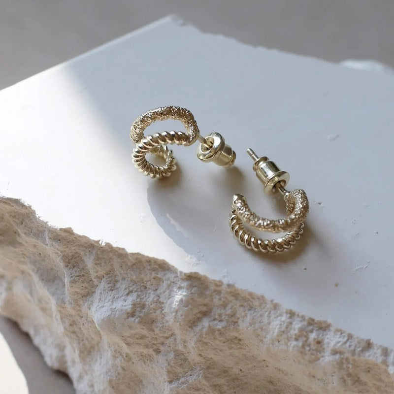 Tutti & Co Jewellery Braid Earrings Gold EA590G on stone