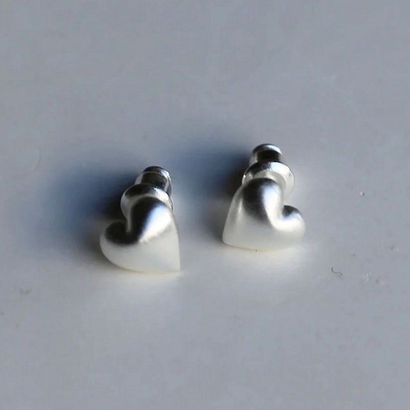 Tutti & Co Jewellery Embrace Earrings Silver EA592S on stone