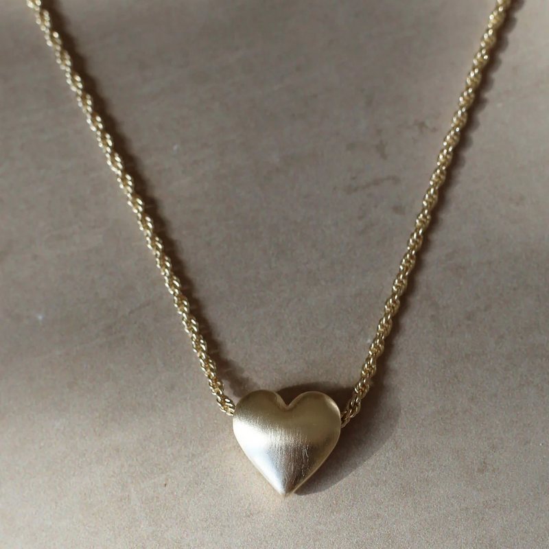 Tutti & Co Jewellery Embrace Necklace Gold NE688G on stone