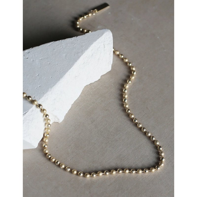 Tutti & Co Valley Necklace Gold NE699G on stone