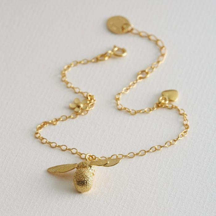 Alex Monroe Baby Bee Bracelet Gold Plated on paper background