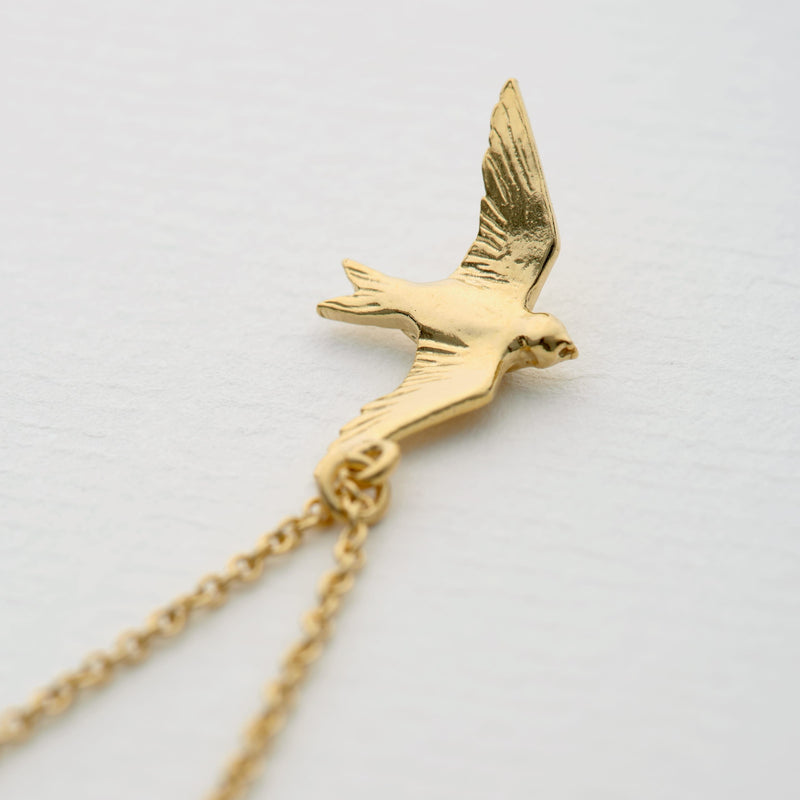 Alex Monroe Jewellery Flying Swallow Necklace Gold Plated DN1-GP on paper