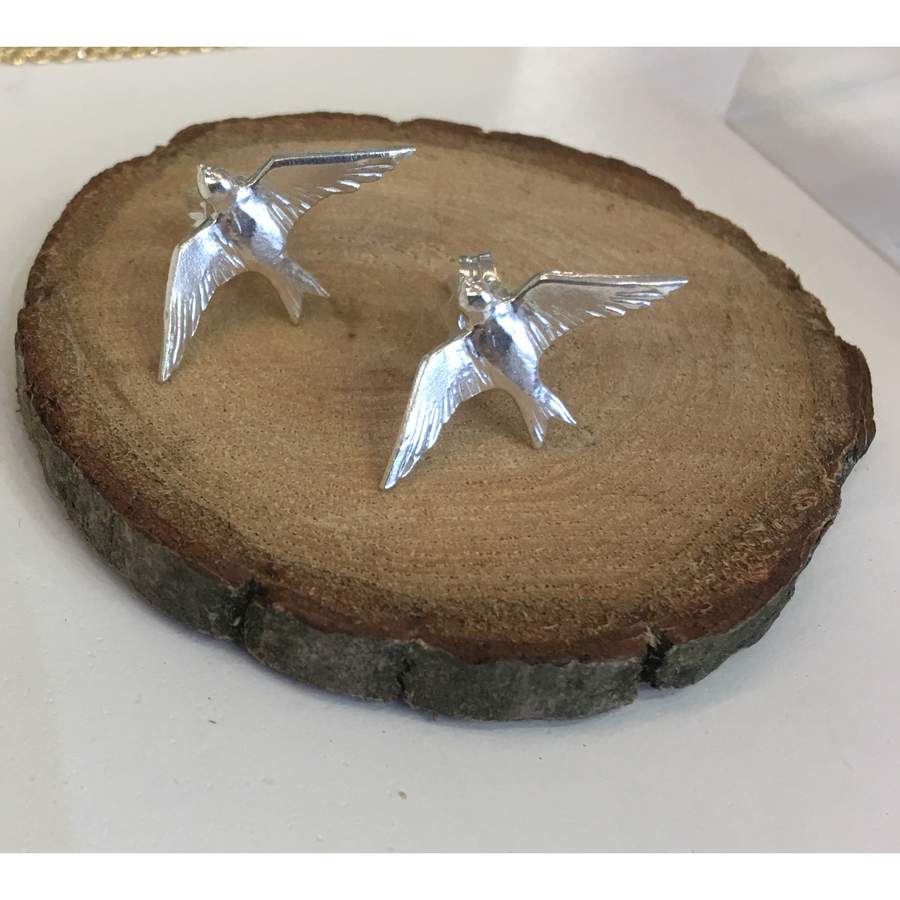 Alex Monroe Flying Swallow Stud Earrings Silver DE2-S on wood
