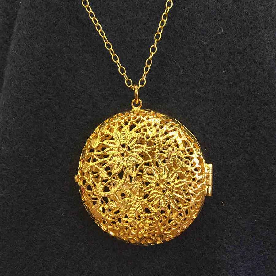Alex Monroe Jewellery Large Chantilly Lace Locket Gold Plate on navy scarf