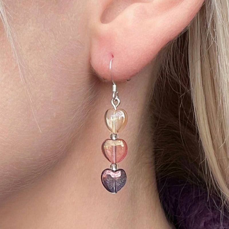 Carrie Elspeth Jewellery Pink & Purple Lustre Hearts Earrings EH1802A on model