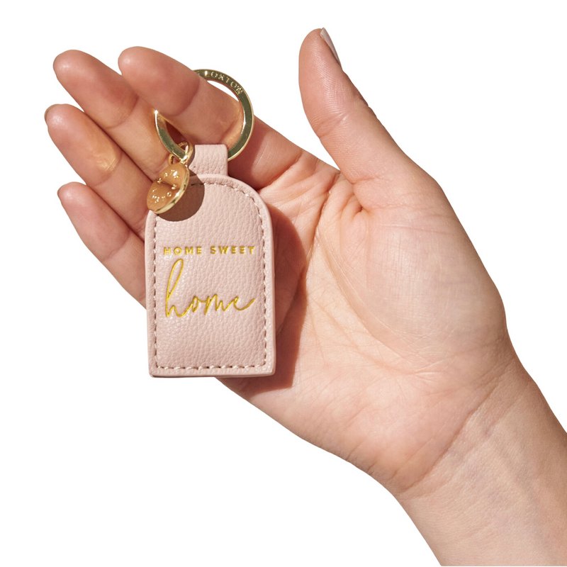 Katie Loxton Keyring Home Sweet Home Pink KLB2354 held by model