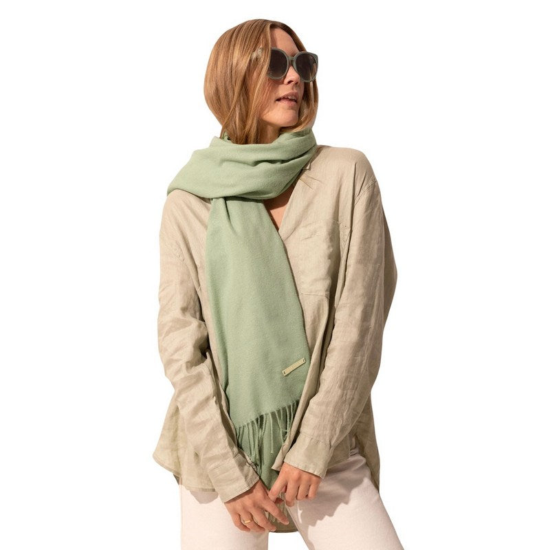 Katie Loxton Sustainable Style Blanket Scarf in Sage Green KLS419 on model