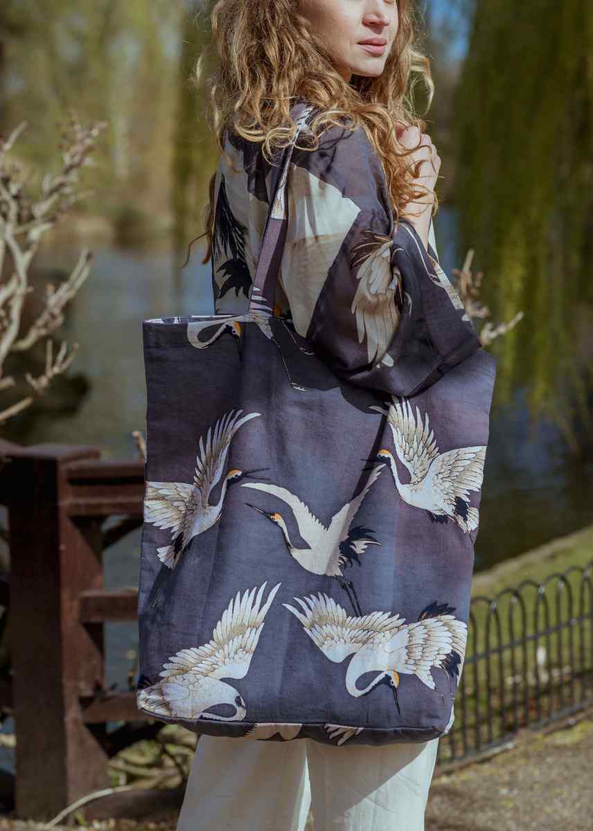 Model wearing One Hundred Stars Stork Charcoal Kimono and matching Bag