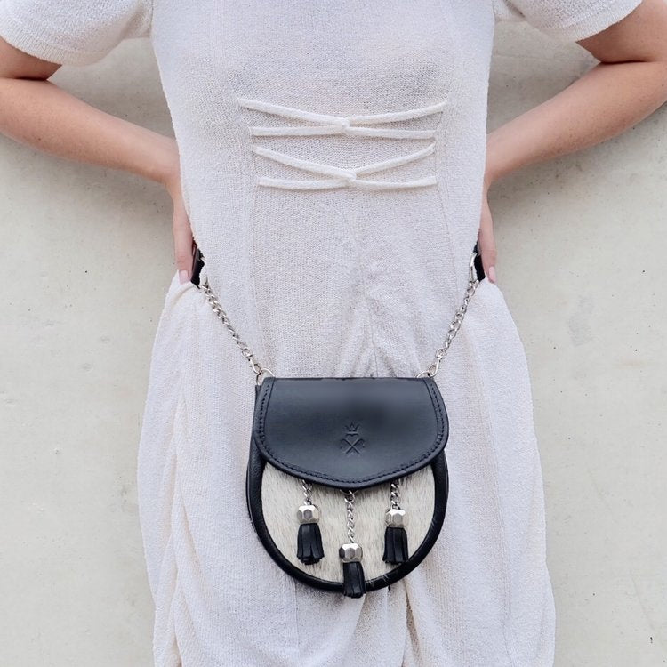 Nixey Sporran Handbag in Light Hair-on Hide in Black with Chrome Fittings on model as bum bag