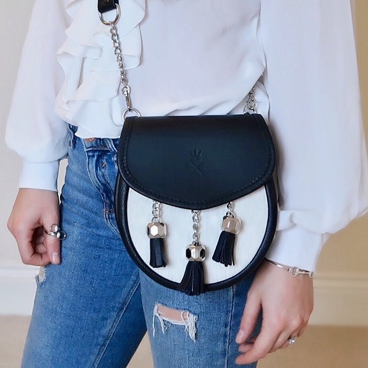 Nixey Sporran Handbag in Light Hair-on Hide in Black with Chrome Fittings on model as cross-body bag
