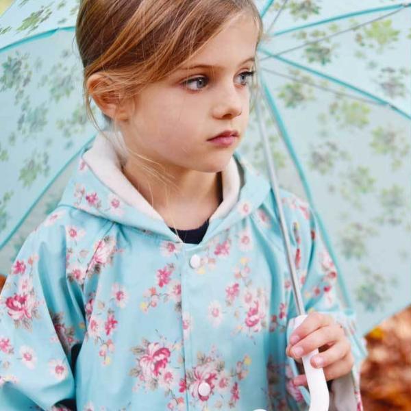 Powell Craft Blue Floral Raincoat on girl with umbrella