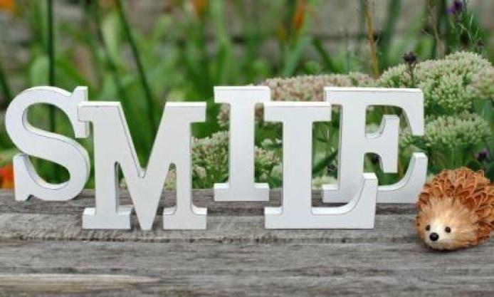 Smile in white wooden letters