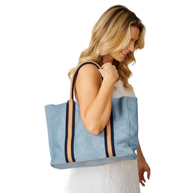 Summer Suede Tote Bag Sky Blue on model's shoulder